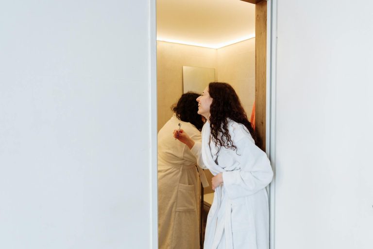 A loving couple enjoys an intimate morning routine in their bathroom, capturing a tender moment.
