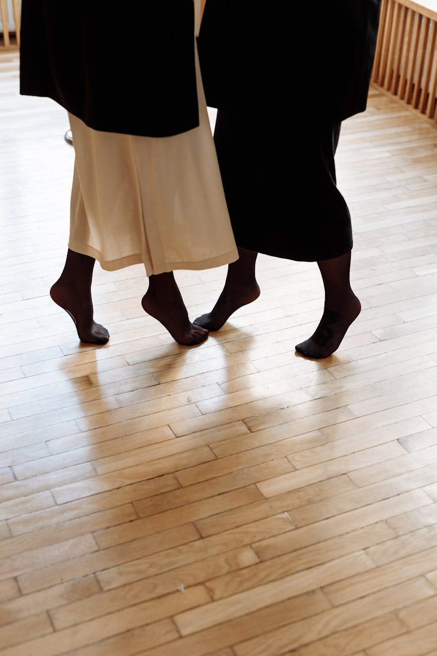 Two people dancing together indoors, showcasing intimacy and connection on a wooden floor.