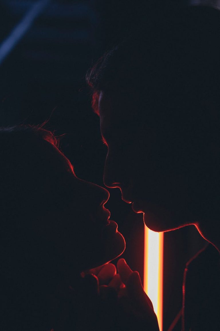 Silhouette of a couple sharing a tender moment in dramatic lighting. Captured in Baku.